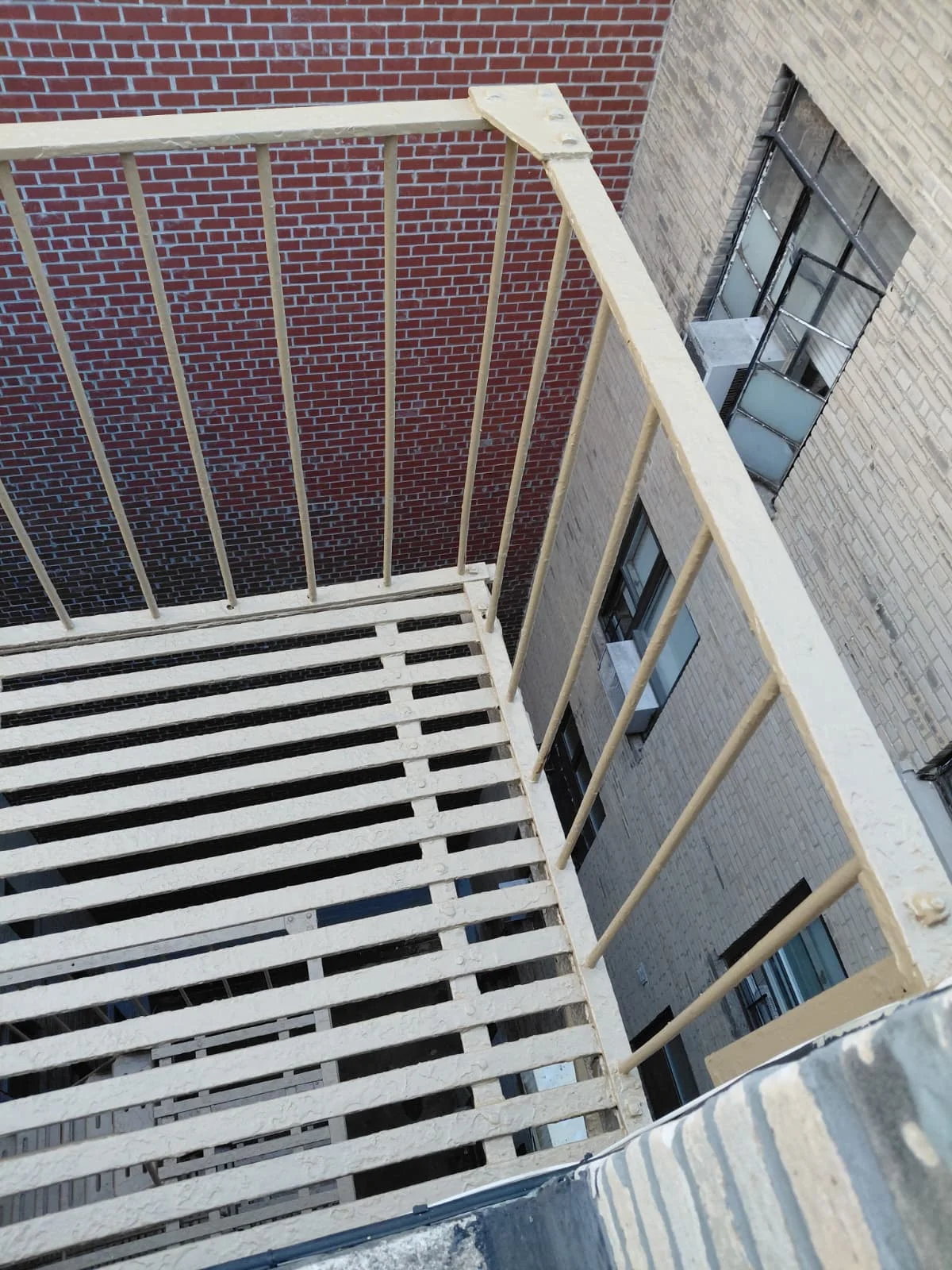 Fire escape restoration NYC with newly coated stairs and structural reinforcement