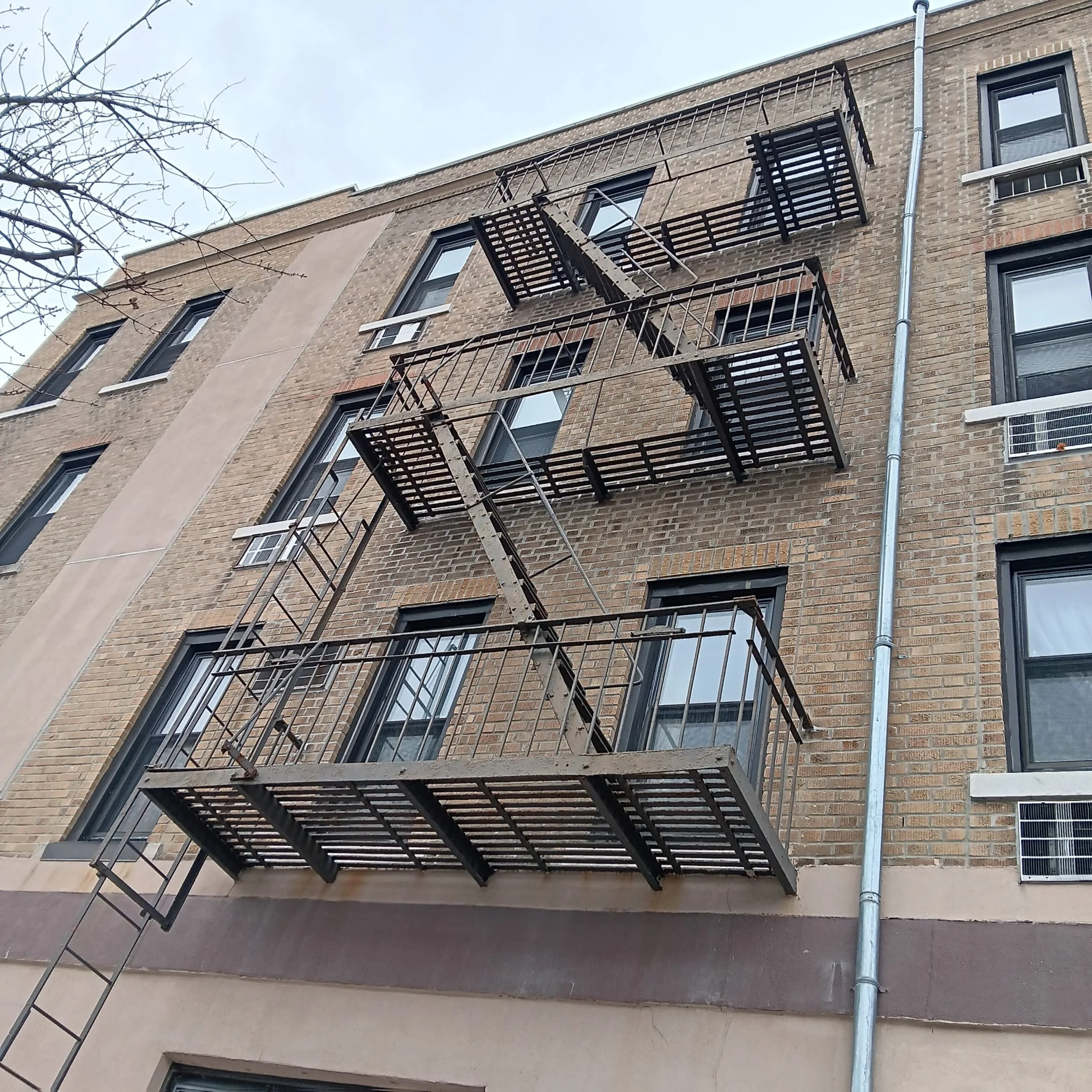 Fire escape contractors NYC working on building fire escape system